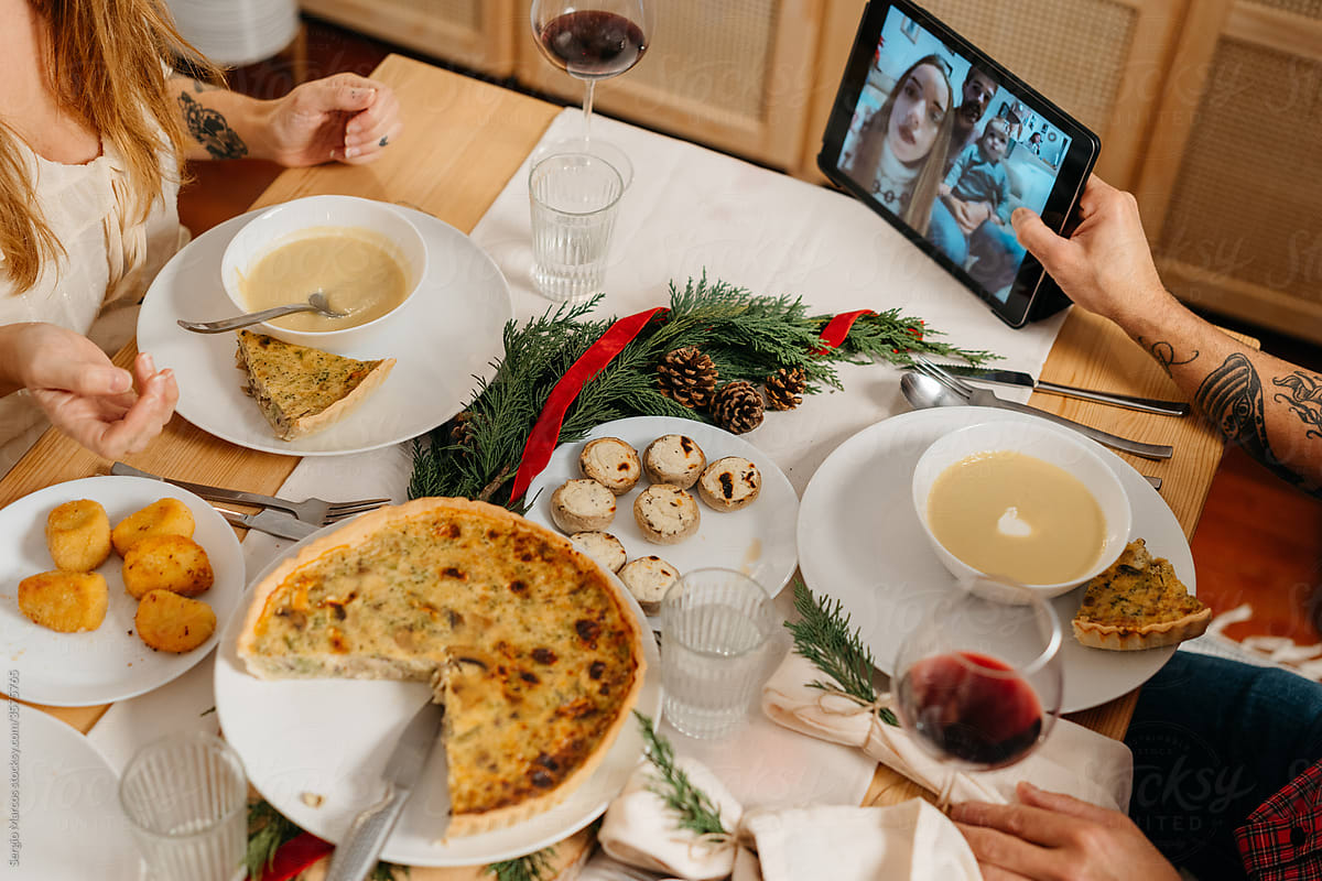 Family doing a videocall during christmas  dinner