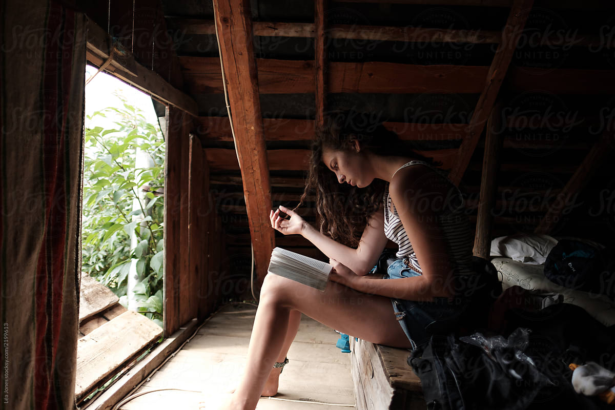 teen reading in a rustic mountain hut in the French Alps