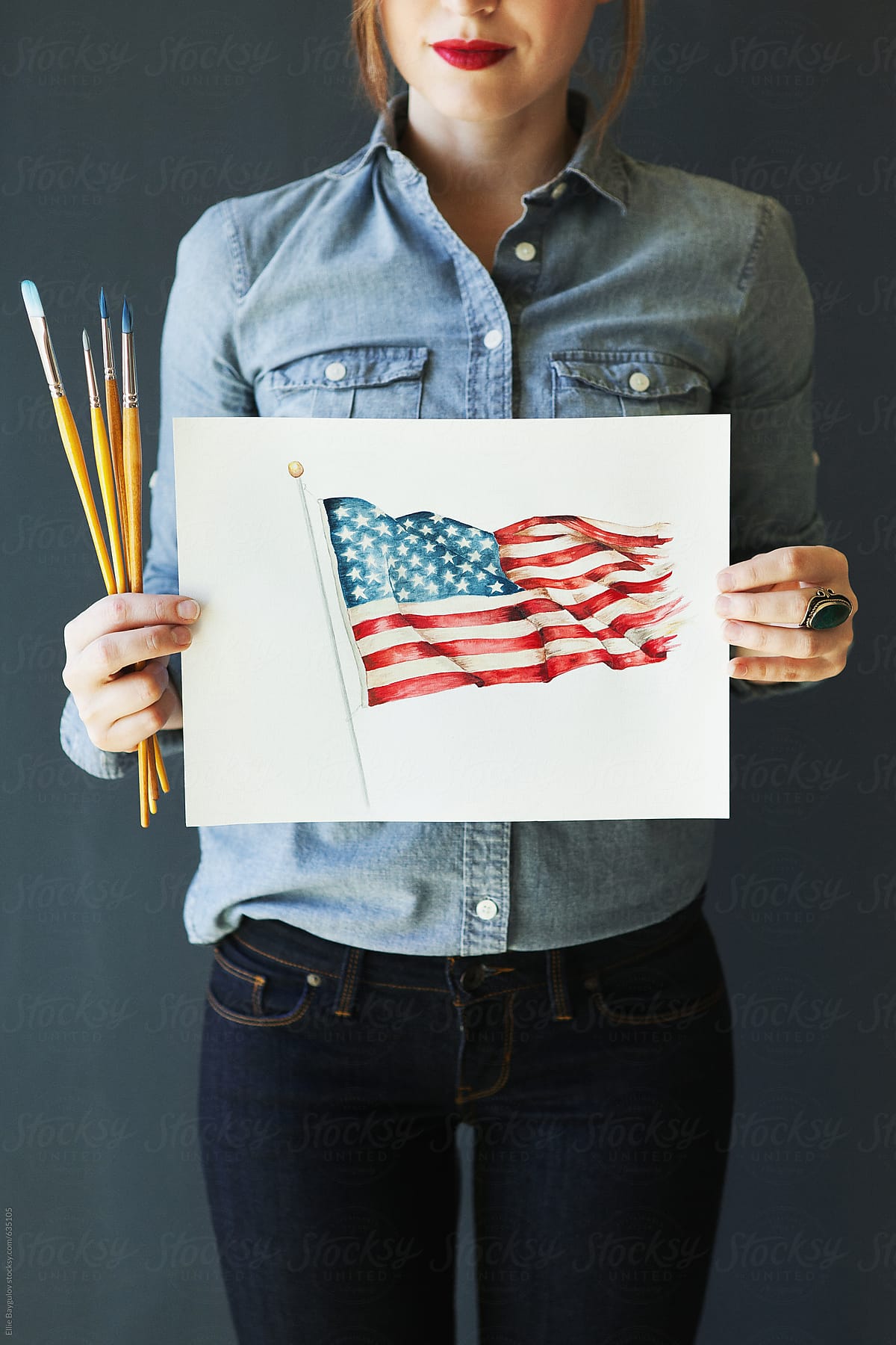 Girl holding an american flag painting