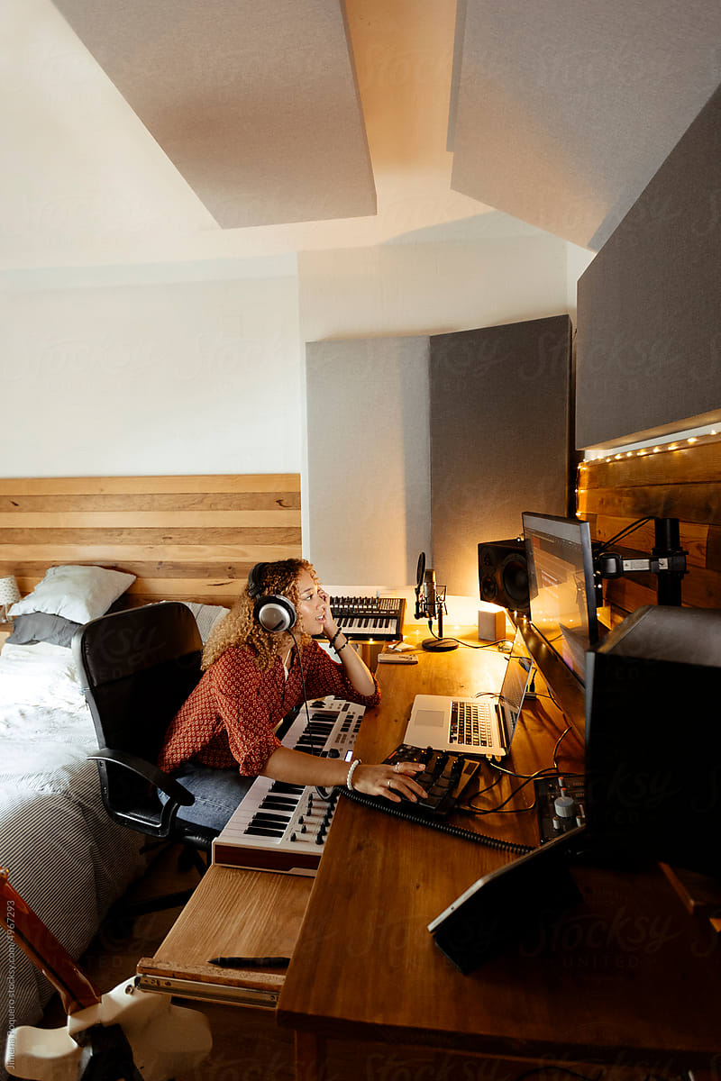 Music producer working at home studio located in bedroom