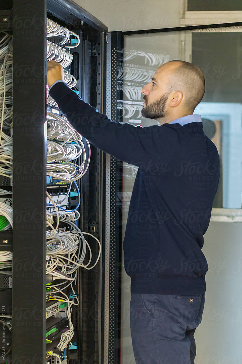 Computer technician man working in a rack server
