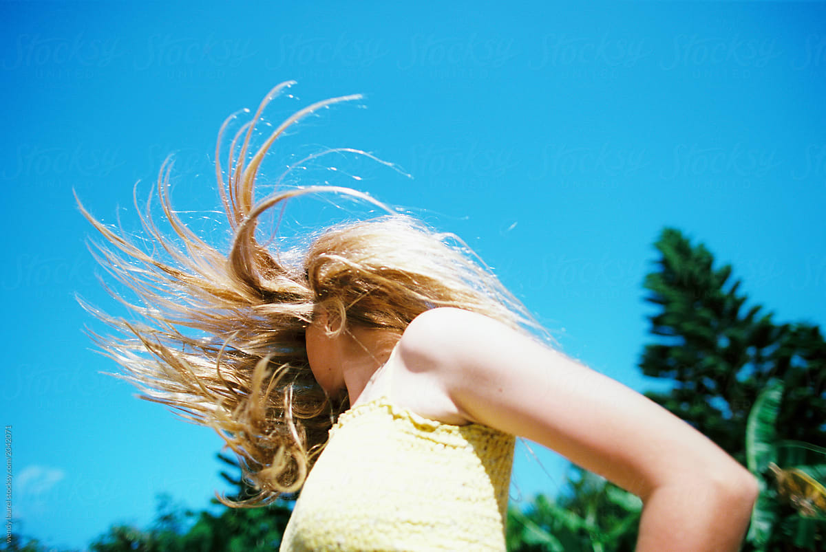 Blonde Teenage Girl With Long Wavy Hair With Bright Colors In