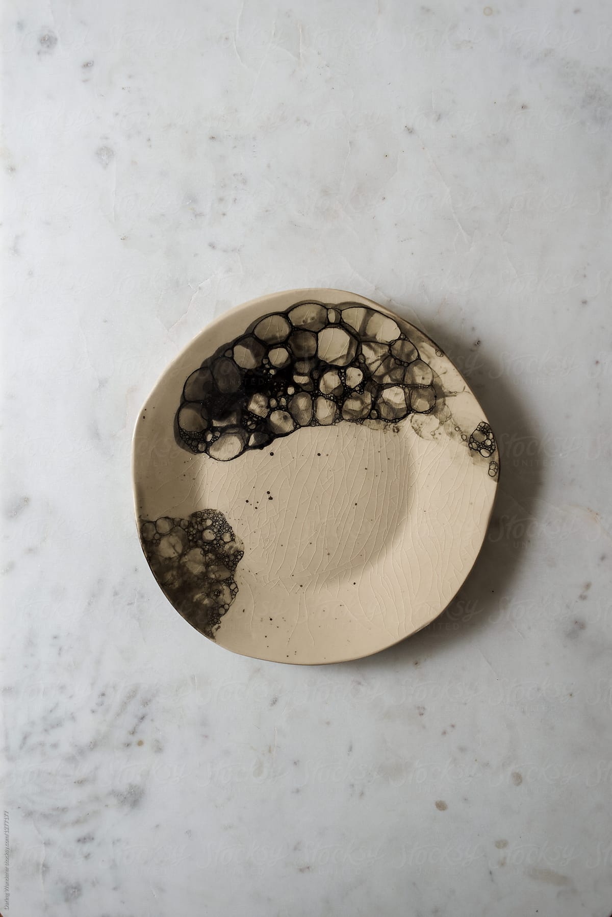 Handmade bubble plate styling on marble table