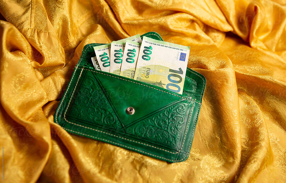 Green purse with lots of money
