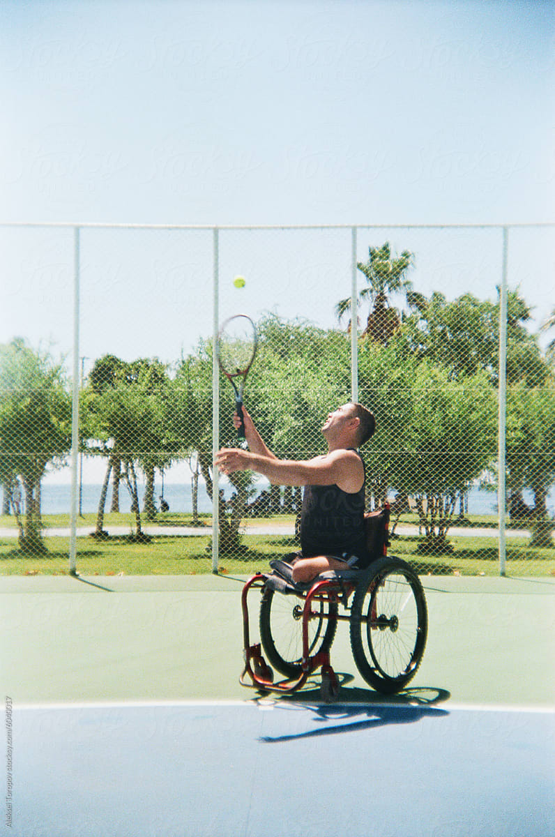 young disabled man plays tennis