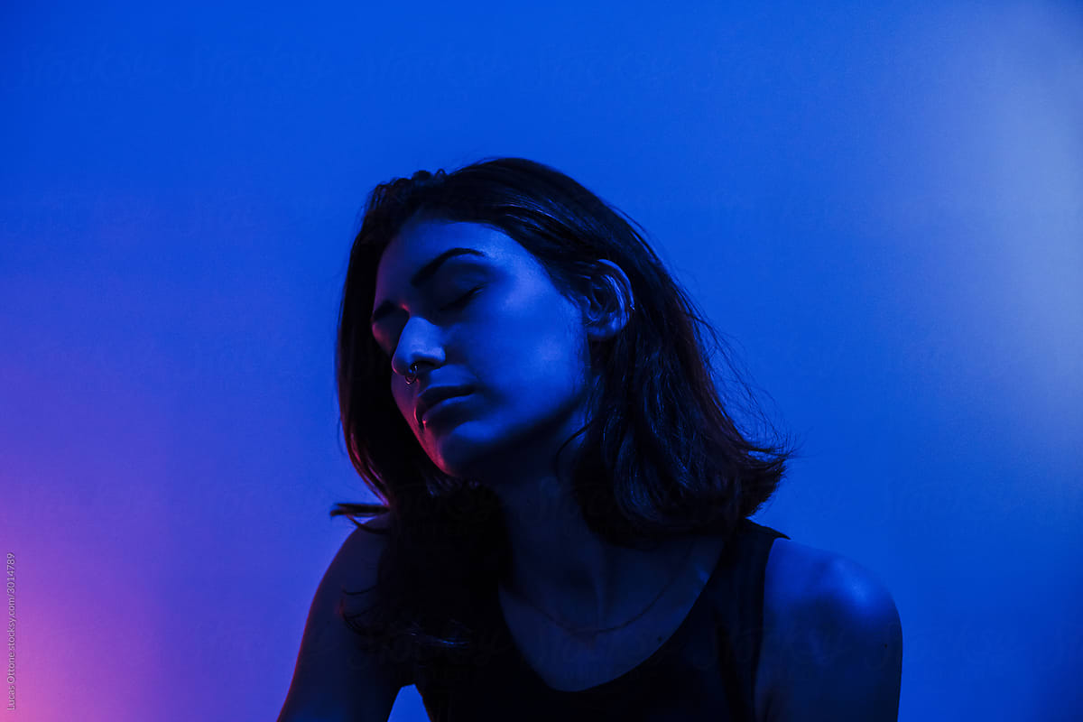 Attractive woman in dark blue light