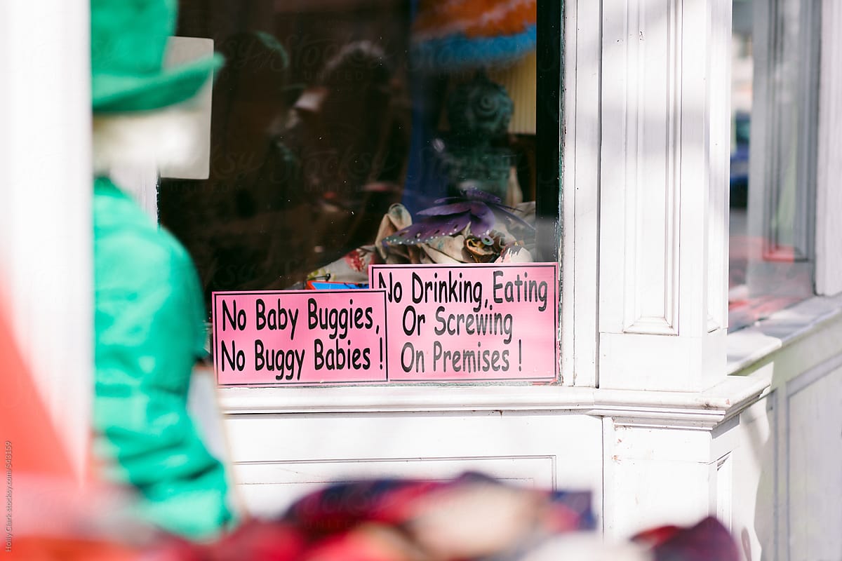 Funny signs in a storefront window.