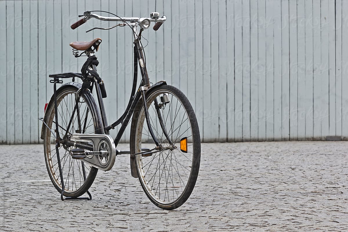 Lone old fashioned bike parked on a square