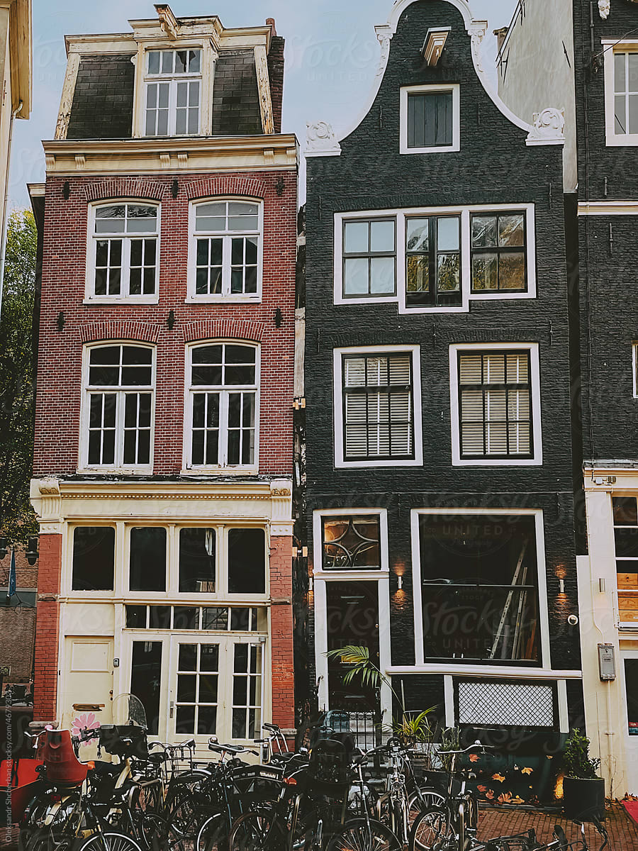 Amsterdam\'s houses with bunch of bicycles on the street