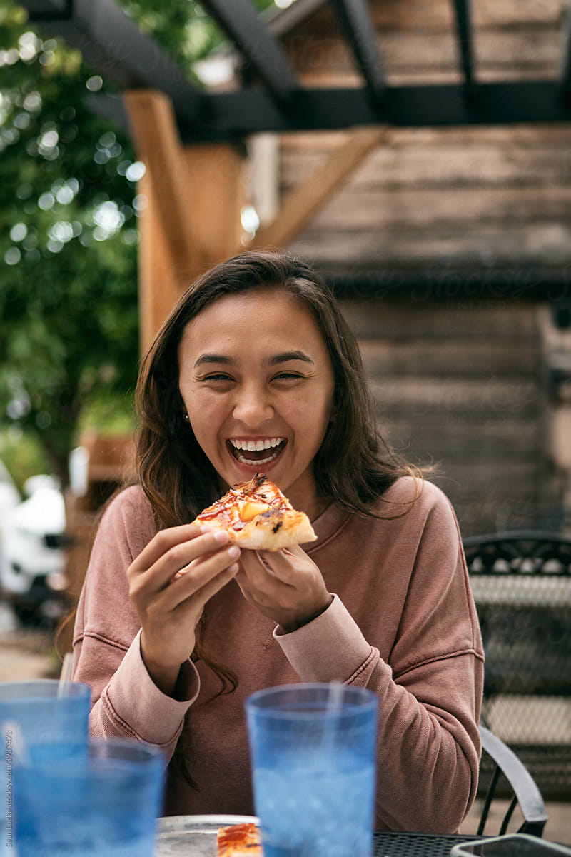 Dining: Woman Having Fun At Pizza Lunch With Friends
