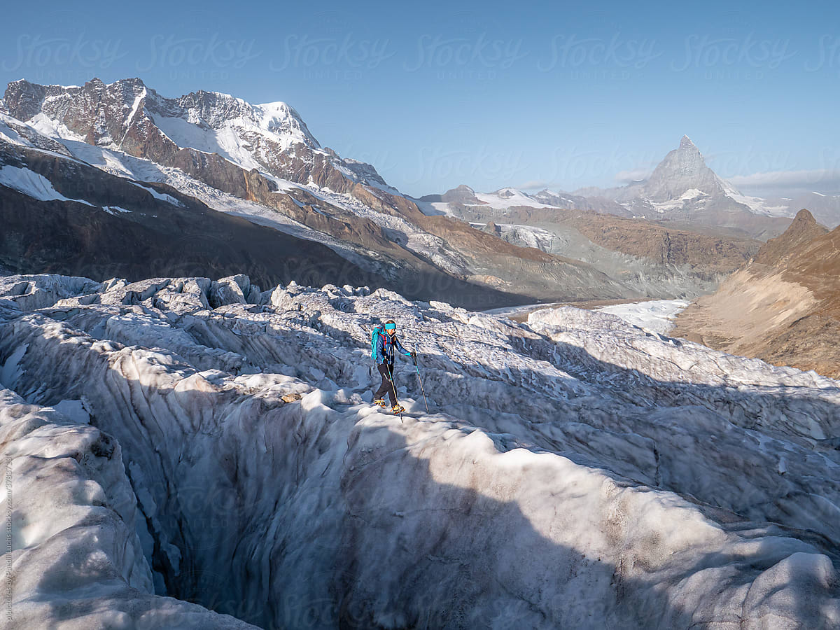 Alpine woman on glacier trekking trip in the alps.
