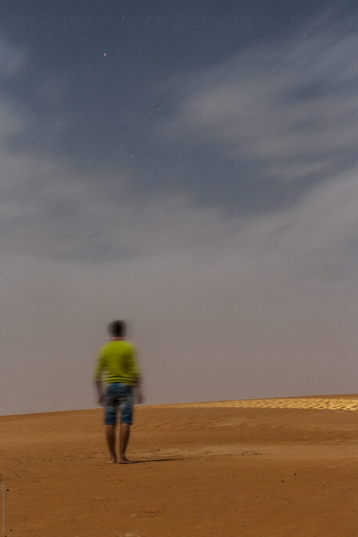 Man walking alone at night in the Desert