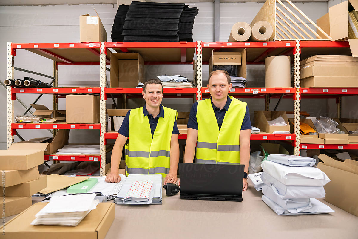 Portrait Of Two Workers At Warehouse