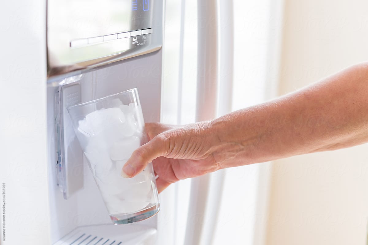Woman Dispenses Filtered Water from Her Fridge