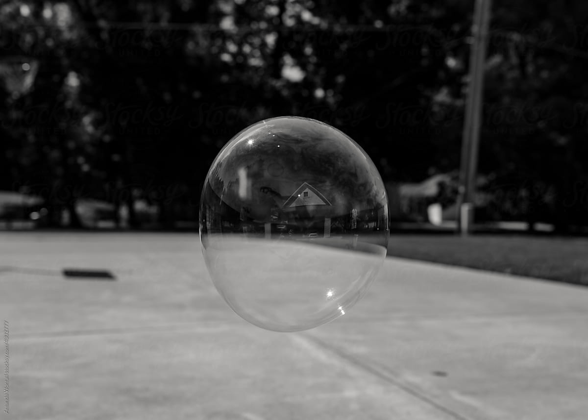 Giant bubble showing reflection of a house