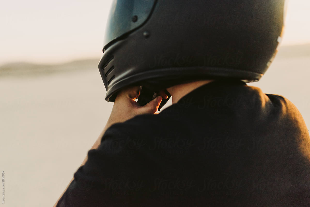 Woman Putting On Motorcycle Helmet By Stocksy Contributor Itla Stocksy 3130