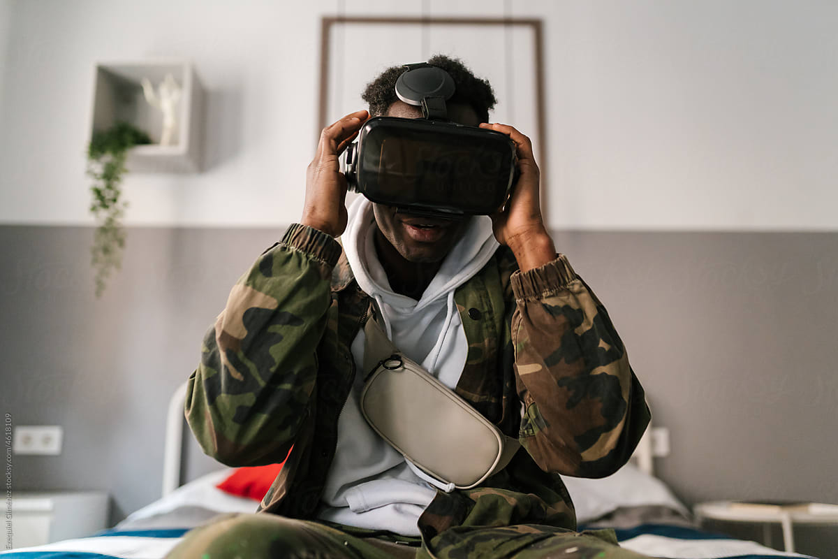African American gamer adjusting VR helmet
