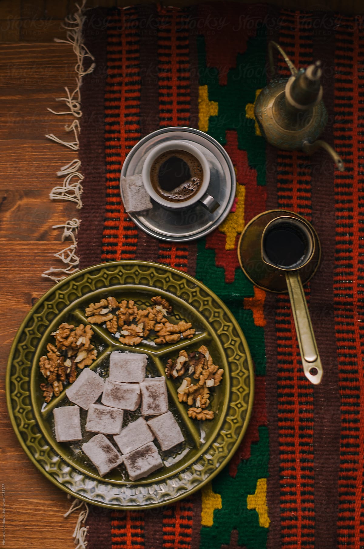 Black coffee with turkish delight and walnuts on the table