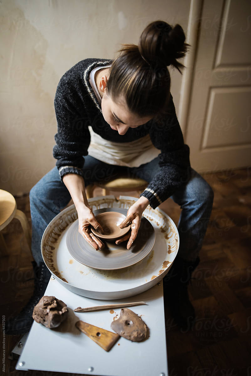 Young Female Potter In Works With A Potter\'s Wheel