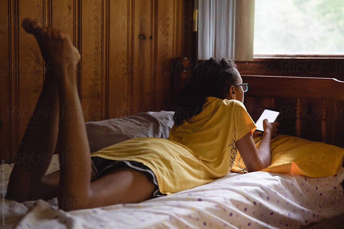 Teenager lying in a quiet bunk while at camp