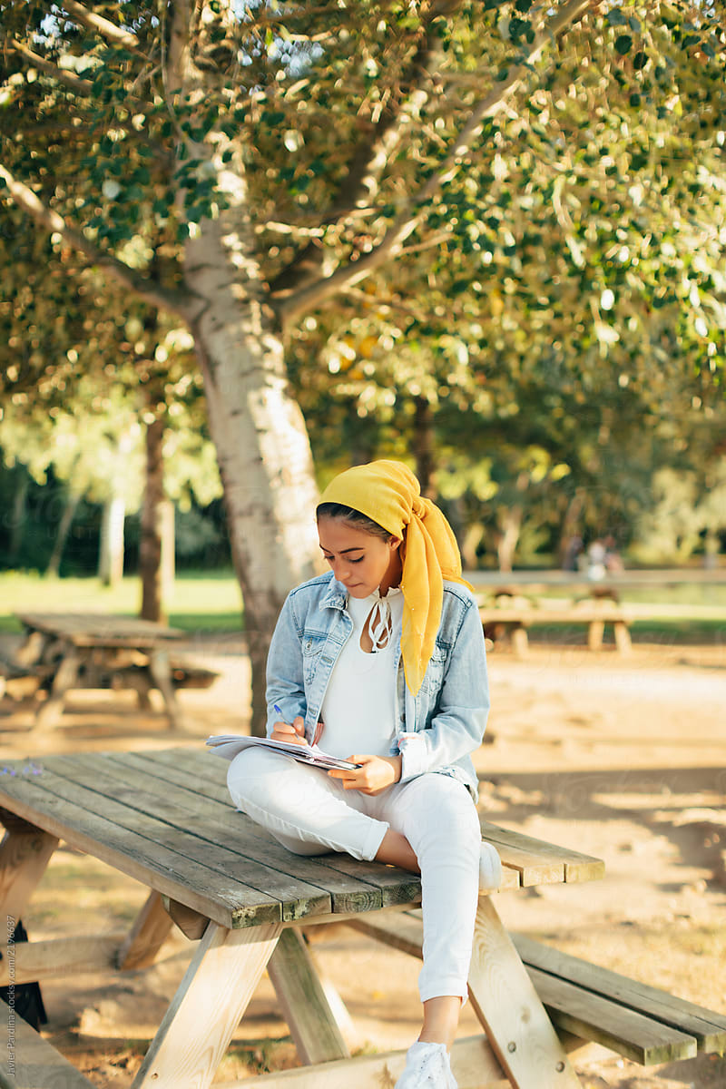 Woman Studying In The Park By Stocksy Contributor Javier Pardina Stocksy