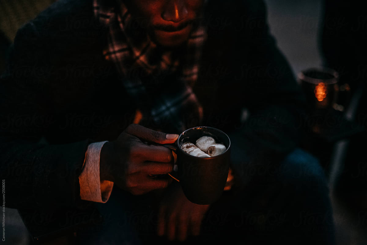 Man drinking hot chocolate outdoors