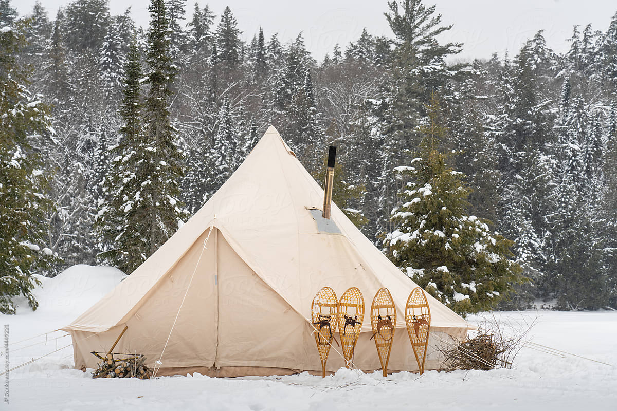 Traditional Winter Tent Campsite with Snowshoes