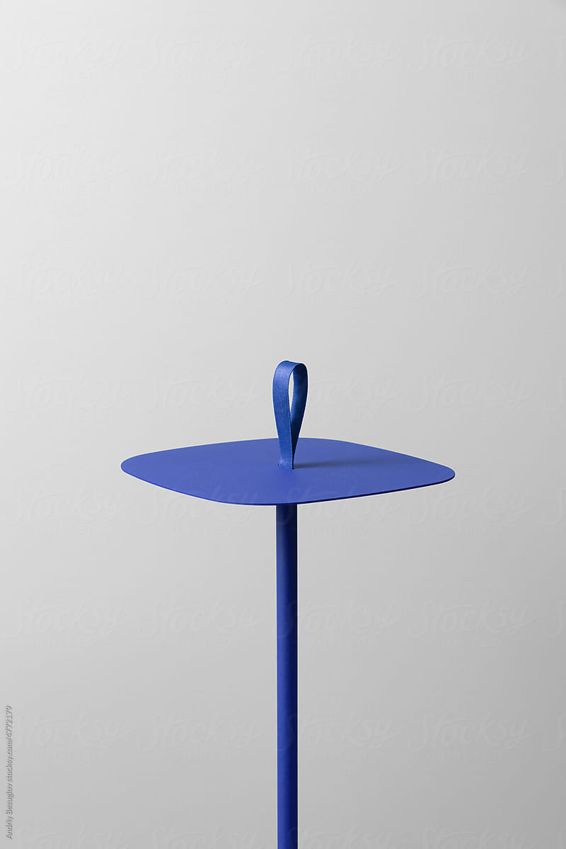Small colorful metal stand with single leg