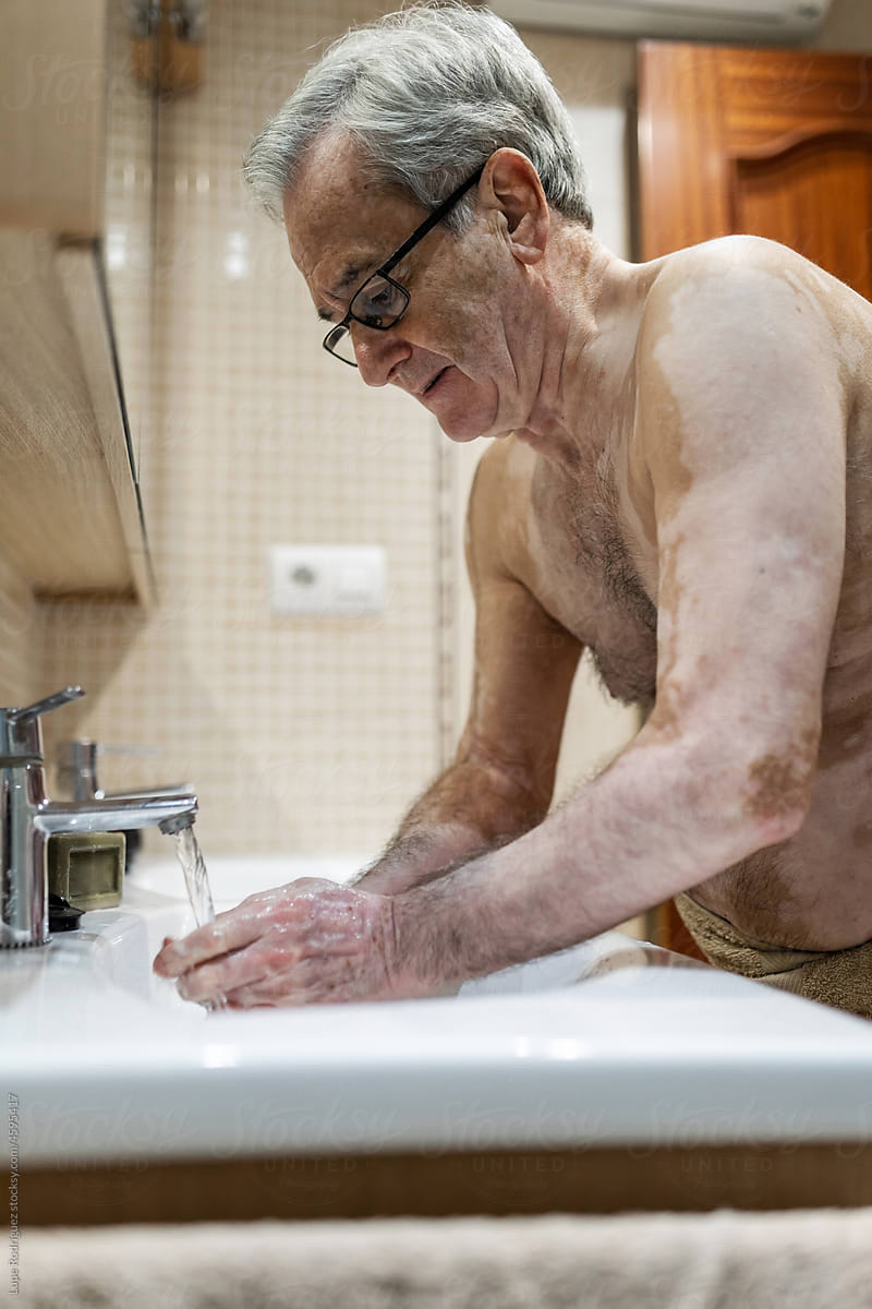 old man washing in the bathroom