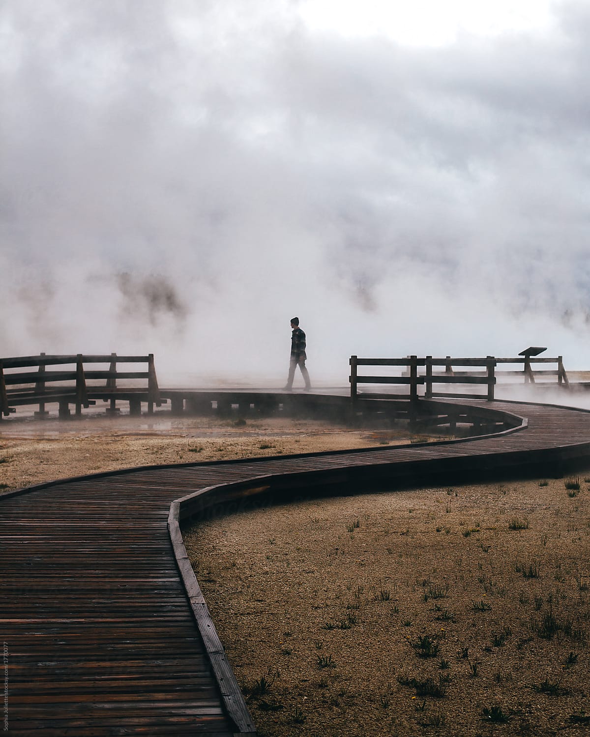 Shadow Of A Person Walking On A Wooden Dock As A Thick Fog