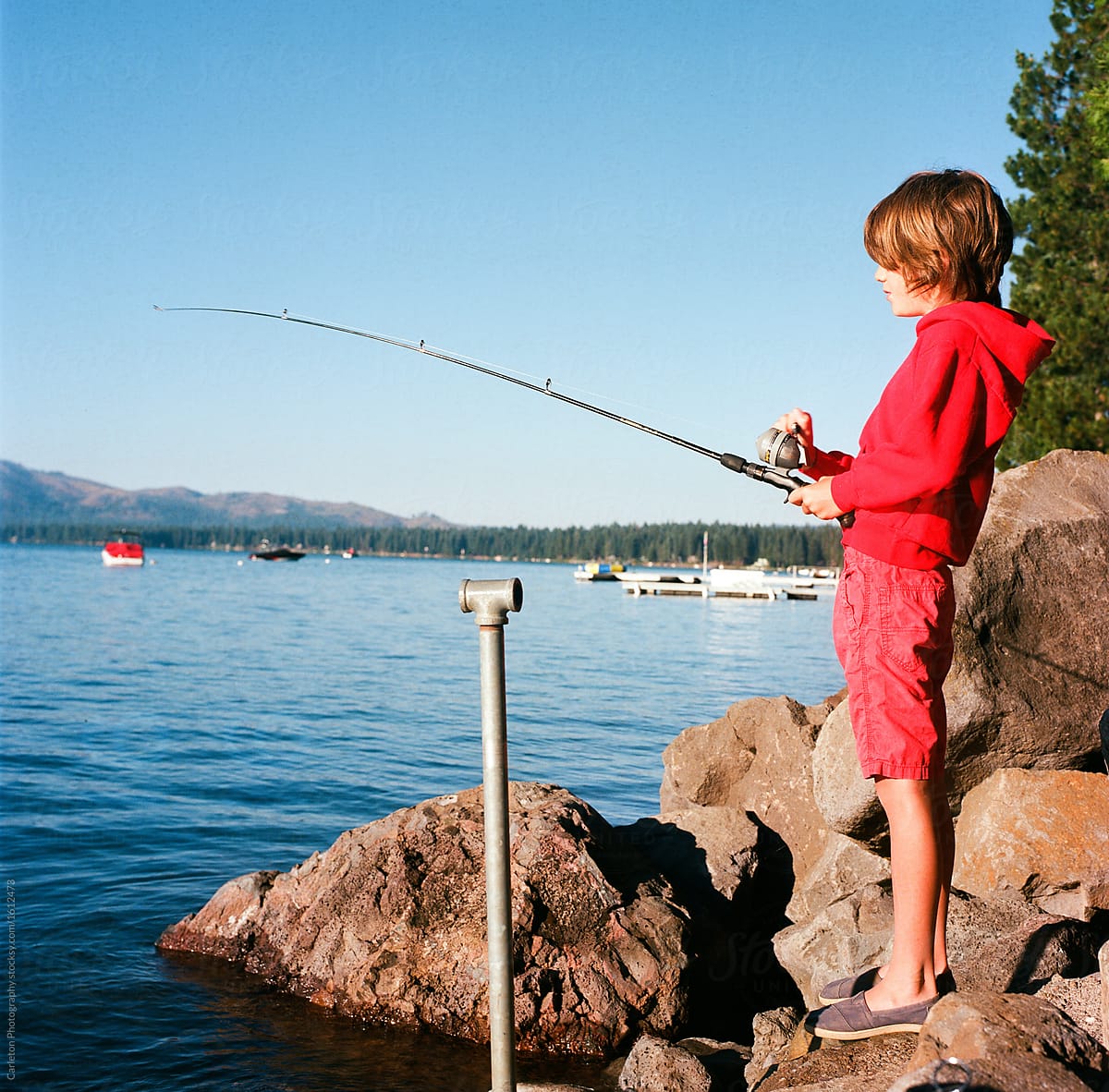 Young Boy Fishing On Lake Almanor by Stocksy Contributor Carleton  Photography - Stocksy