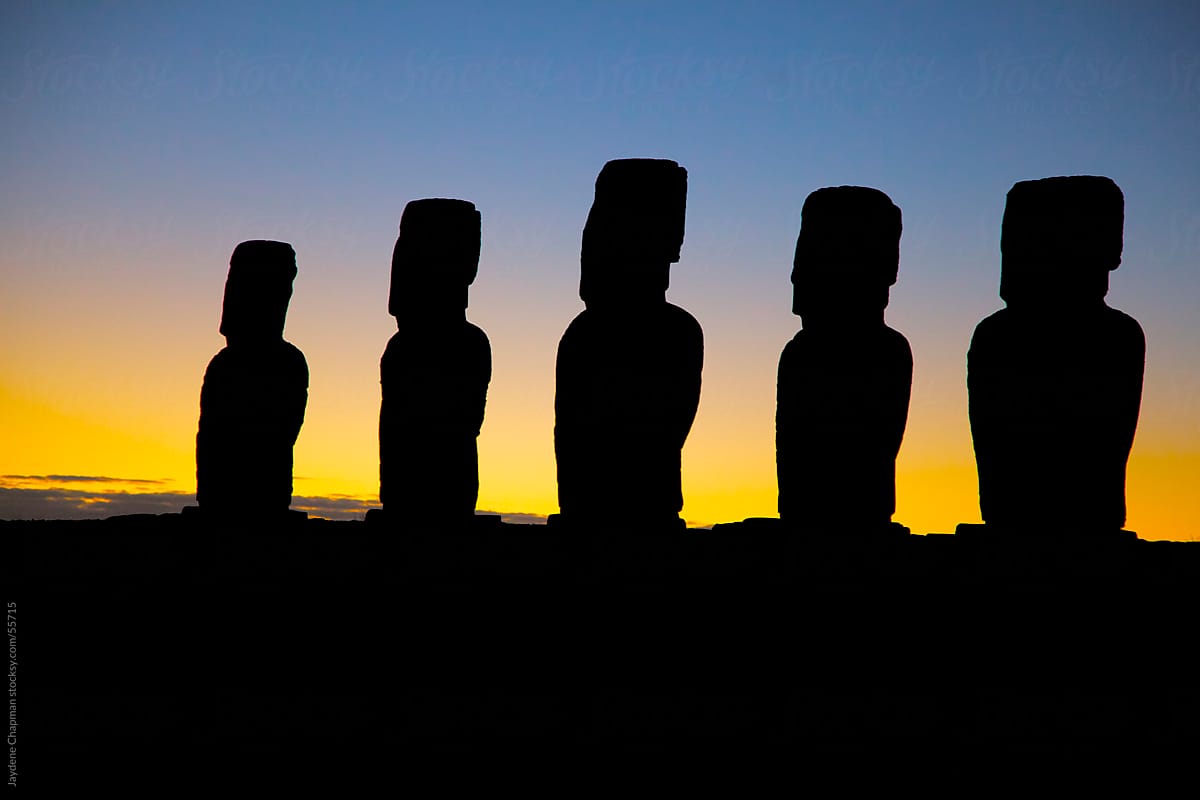 The breaking of Dawn behind five Moai stone statues, Easter Island, Chile