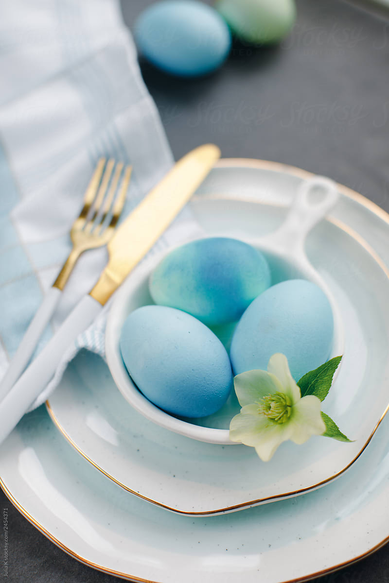 Blue Easter eggs on a beautiful tableware