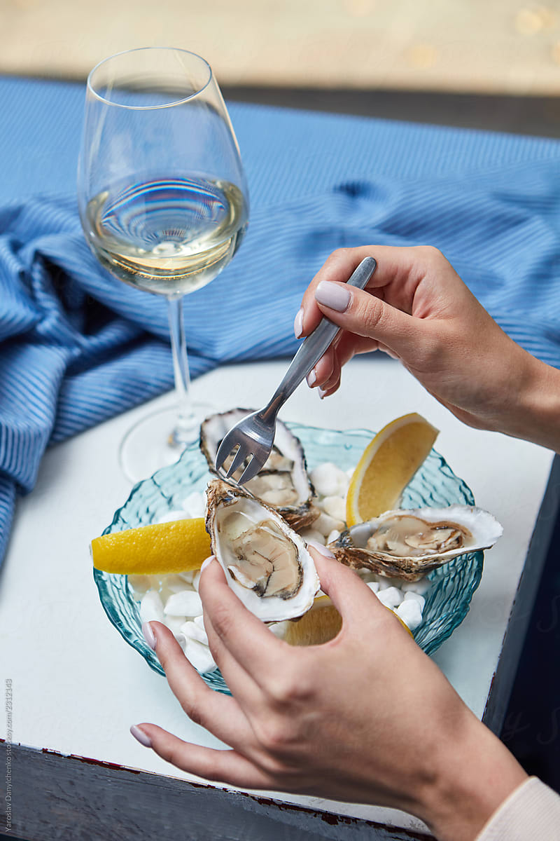 Fresh appetizing oysters with a glass of wine