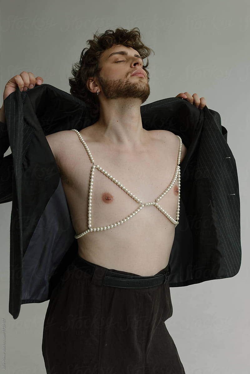 A Curly Guy In A Pearl Bra With Pierced Nipple Takes Off His