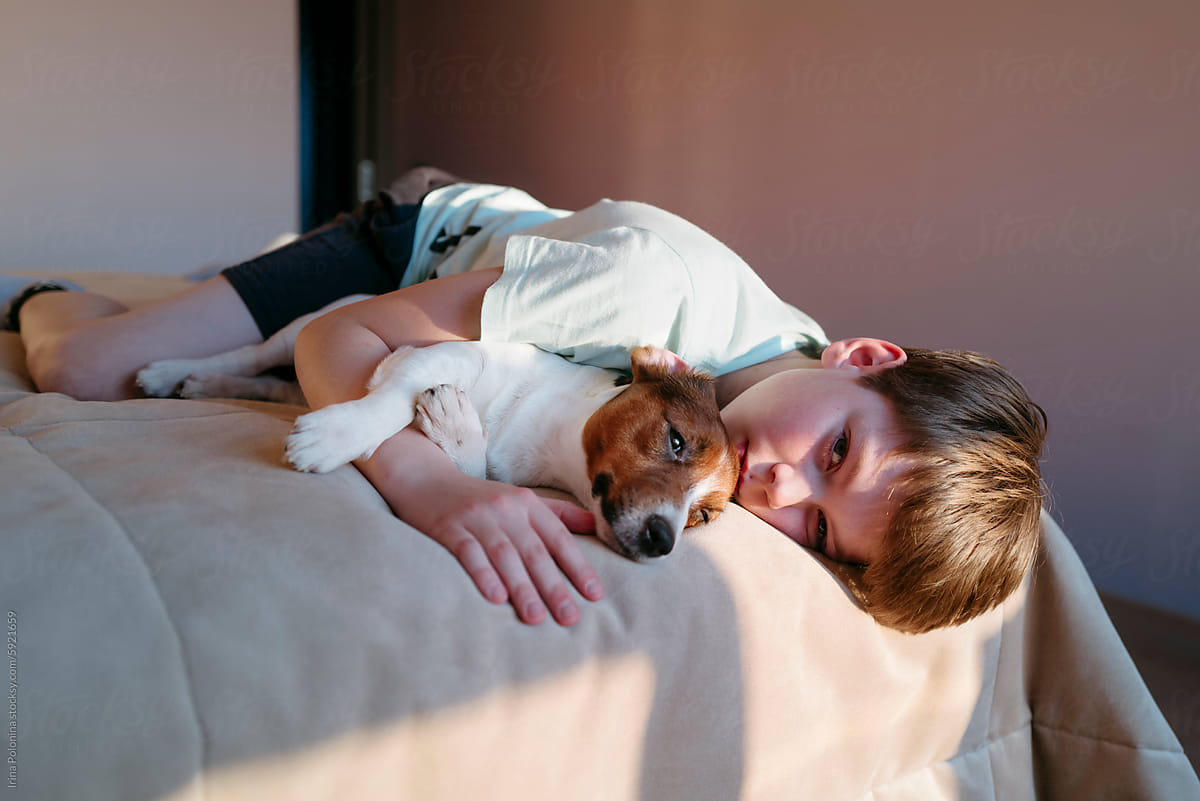 Boy and Dog Lounge on Bed