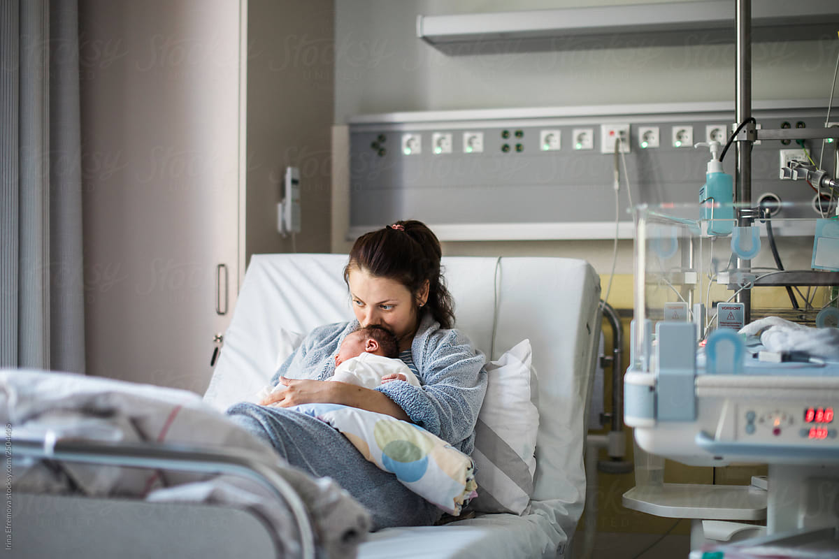 Mother and newborn on a hospital bed