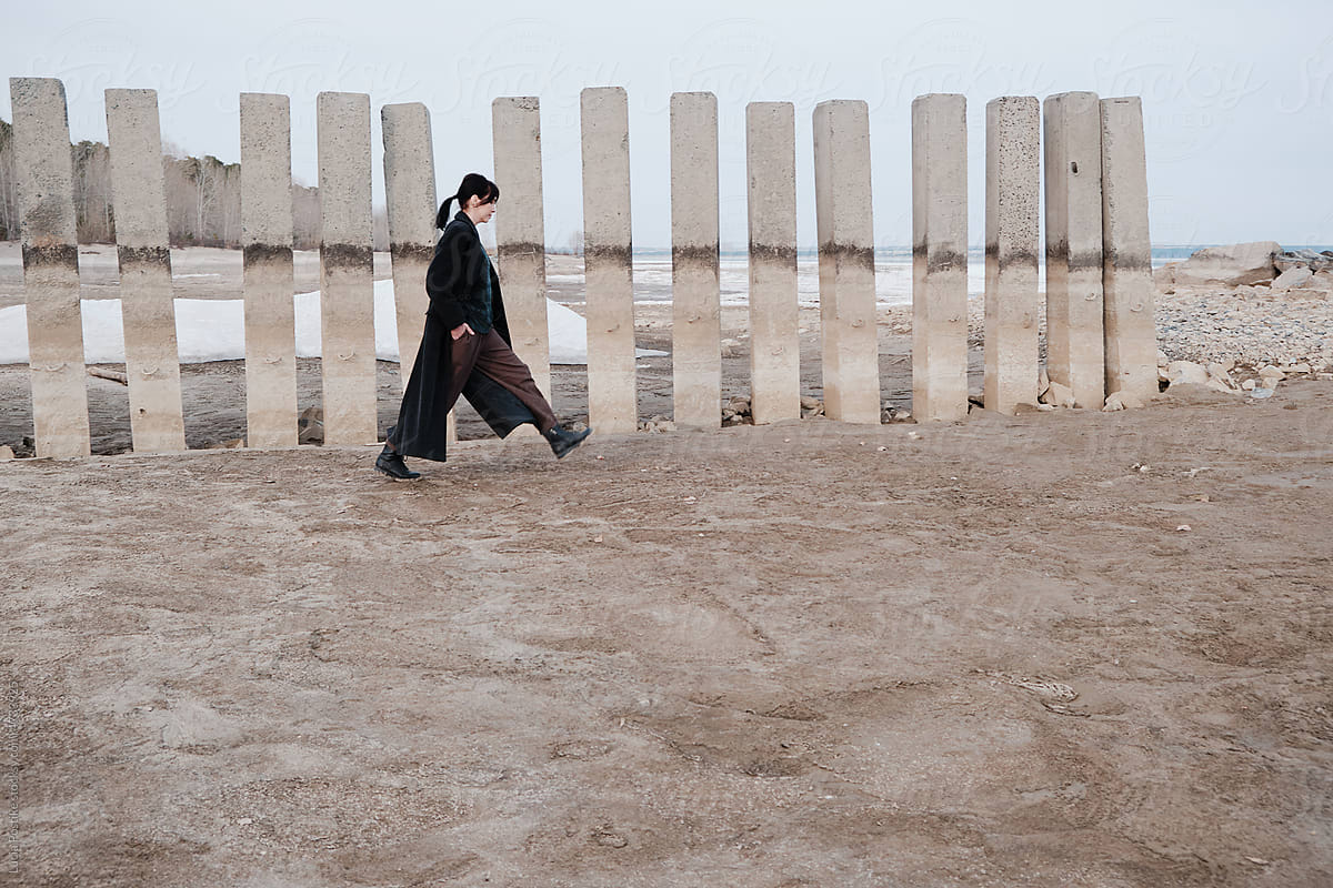Woman walking on sandy winter beach
