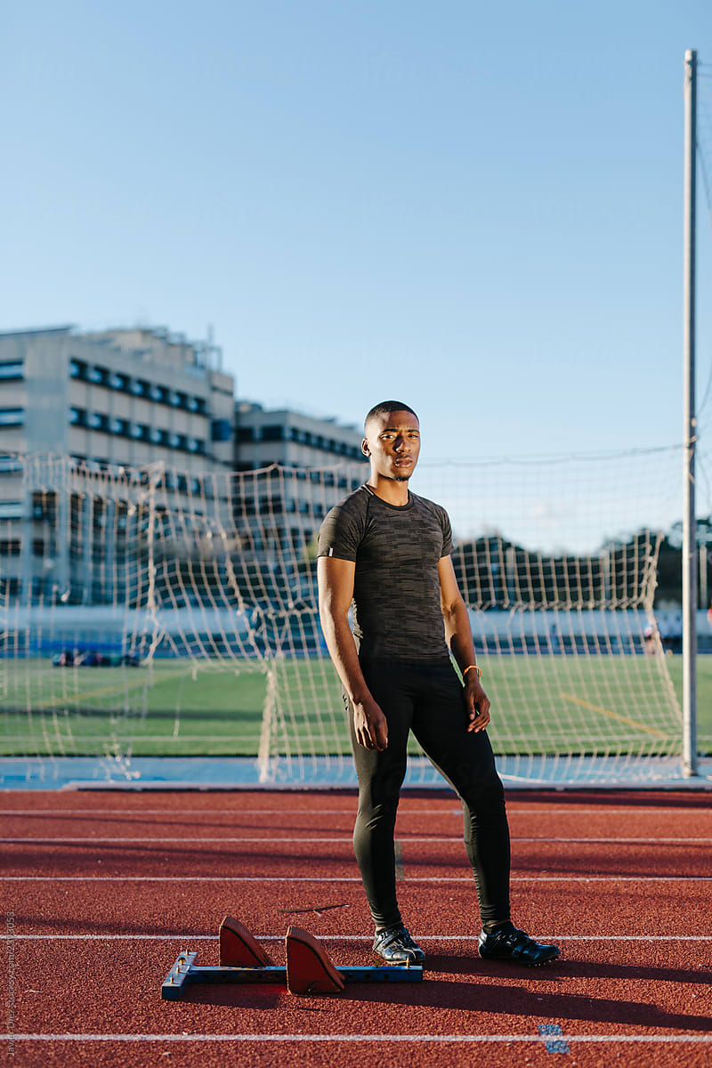 Black sportsman standing on stadium