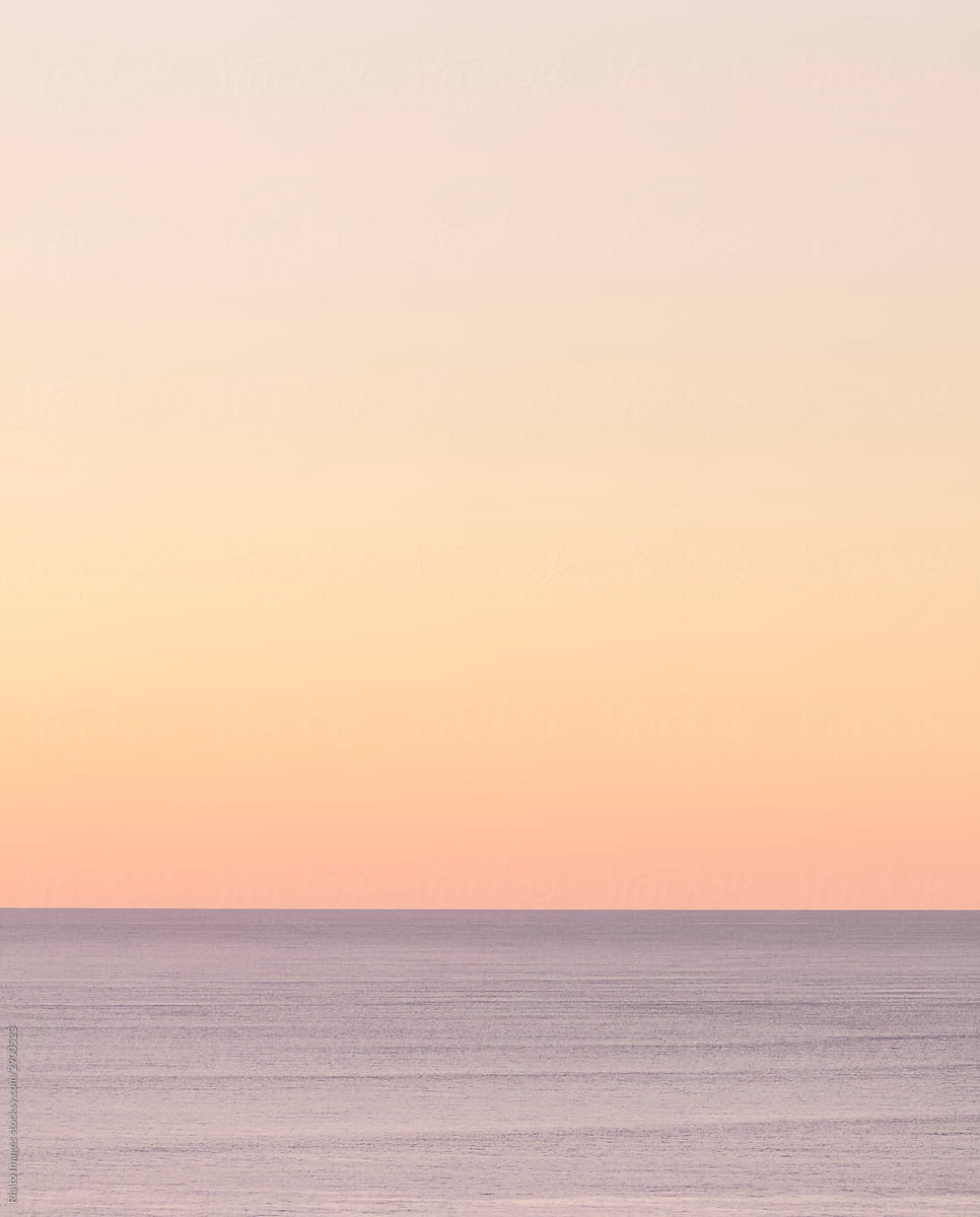 Expansive view of vast ocean, horizon and sky at dawn