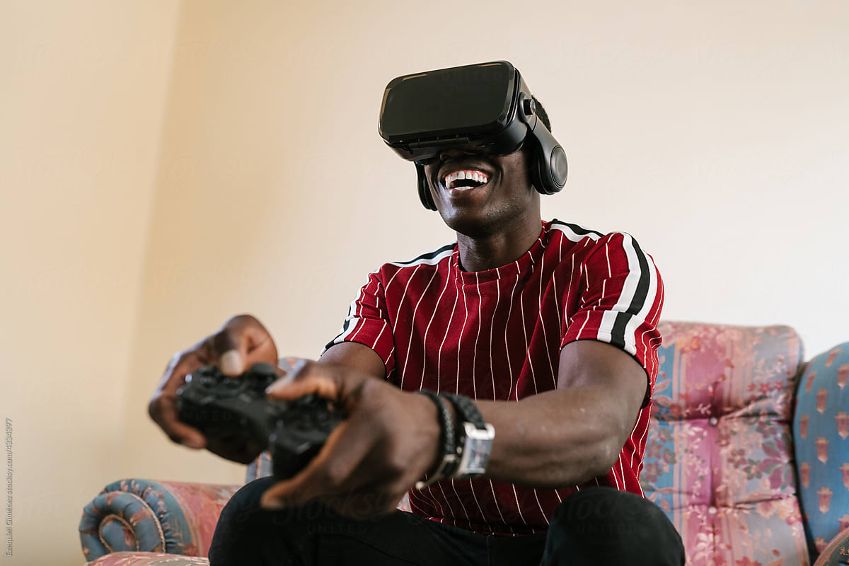 Merry black man playing VR videogame in weekend