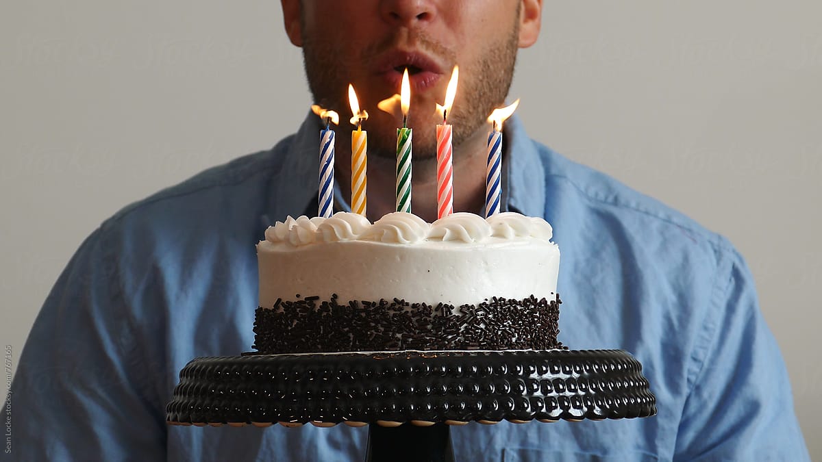 Man Blowing Out Candles