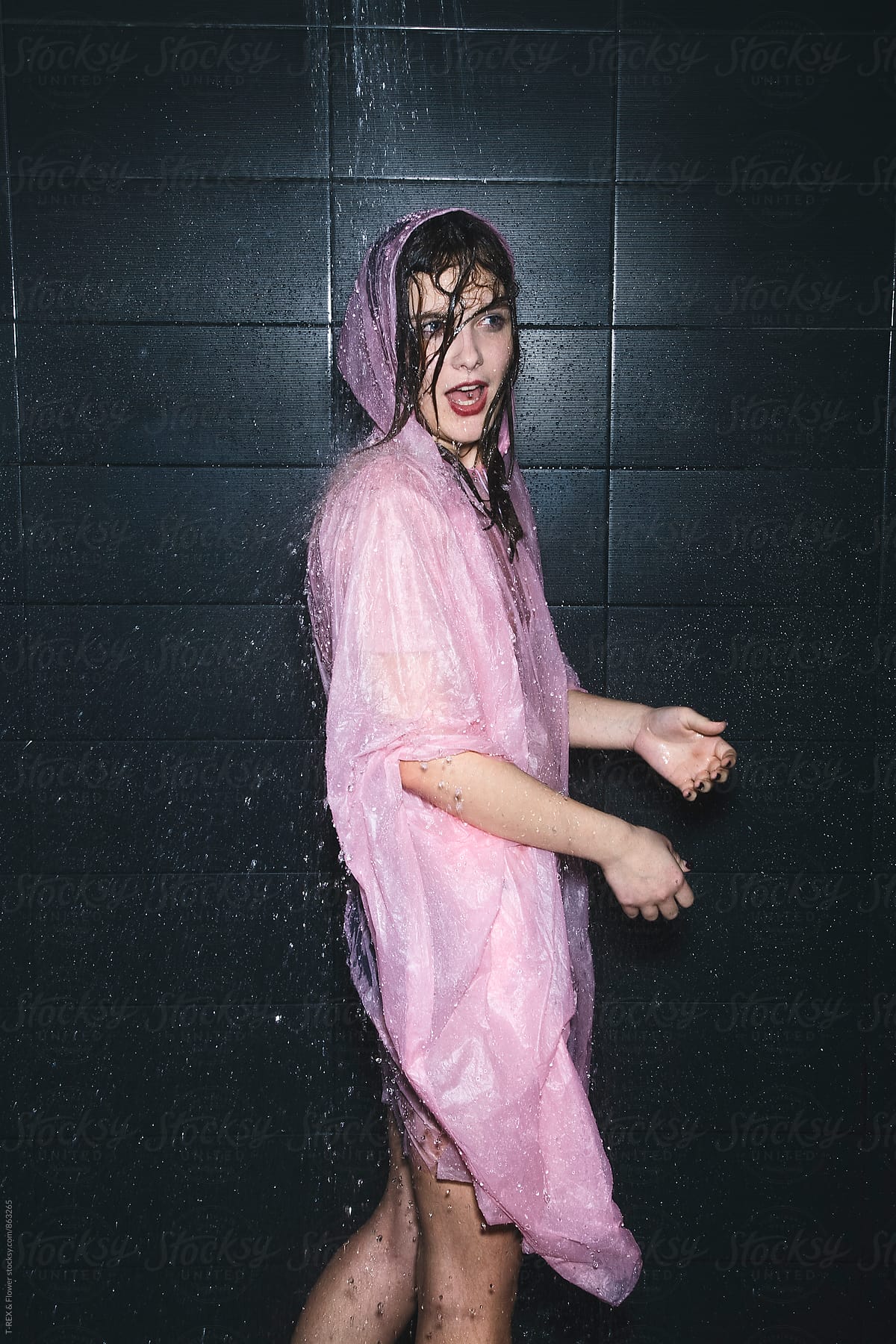 Young woman in pink raincoat with mouth formed an O