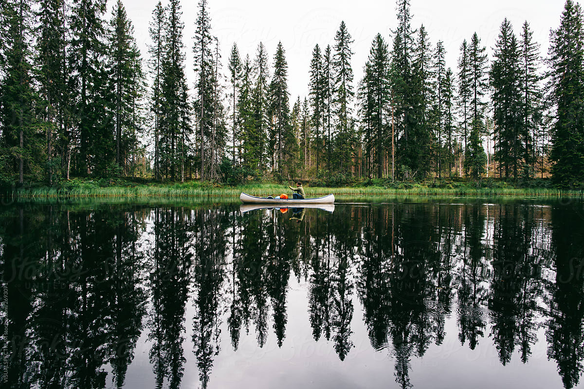 Man Alone in Canoe in Wilderness