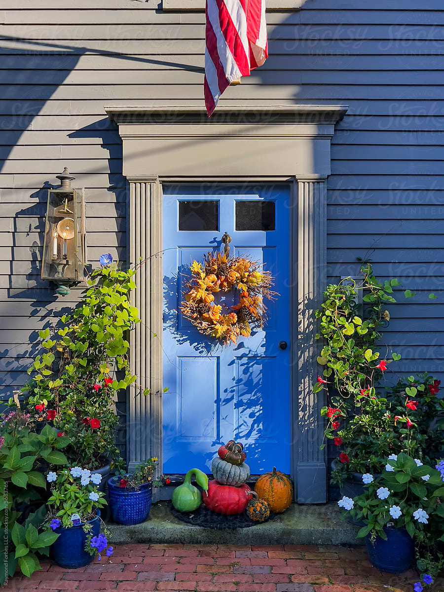 Front Blue Door house with Halloween pumpkin decorations
