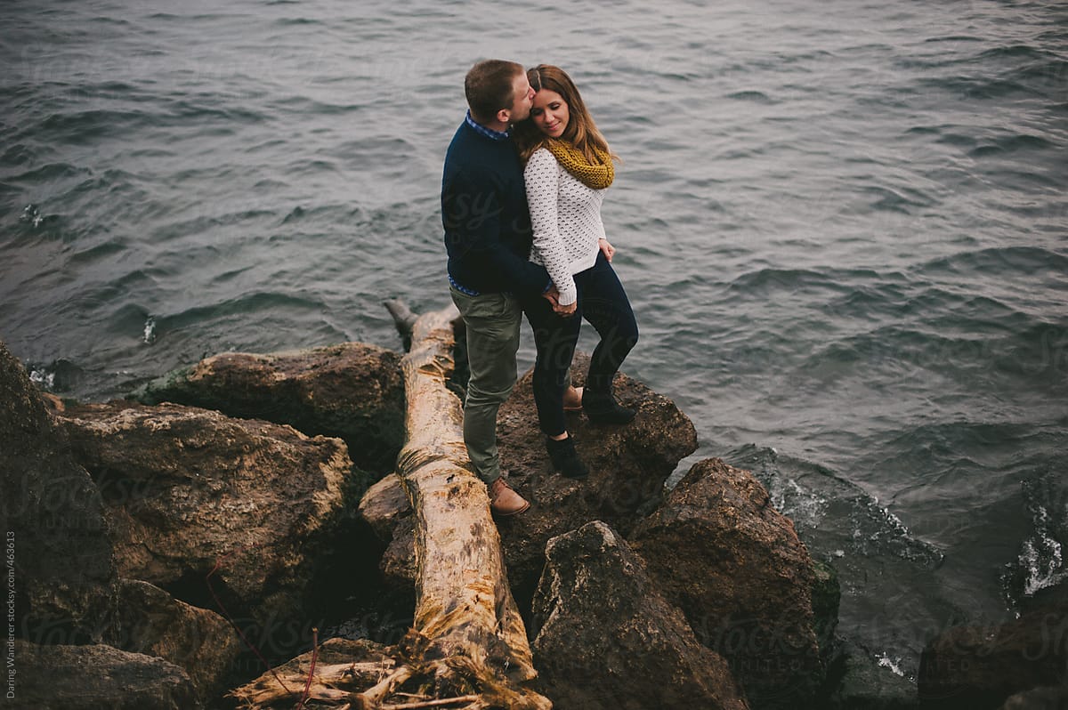 Couple Hugging And Standing On Rocks Beside Lake By Stocksy Contributor Jess Craven Stocksy 