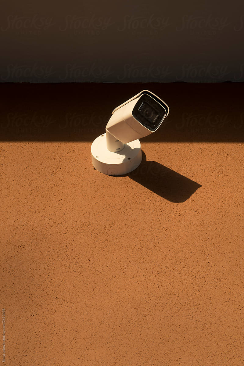 security surveillance camera on orange brown wall
