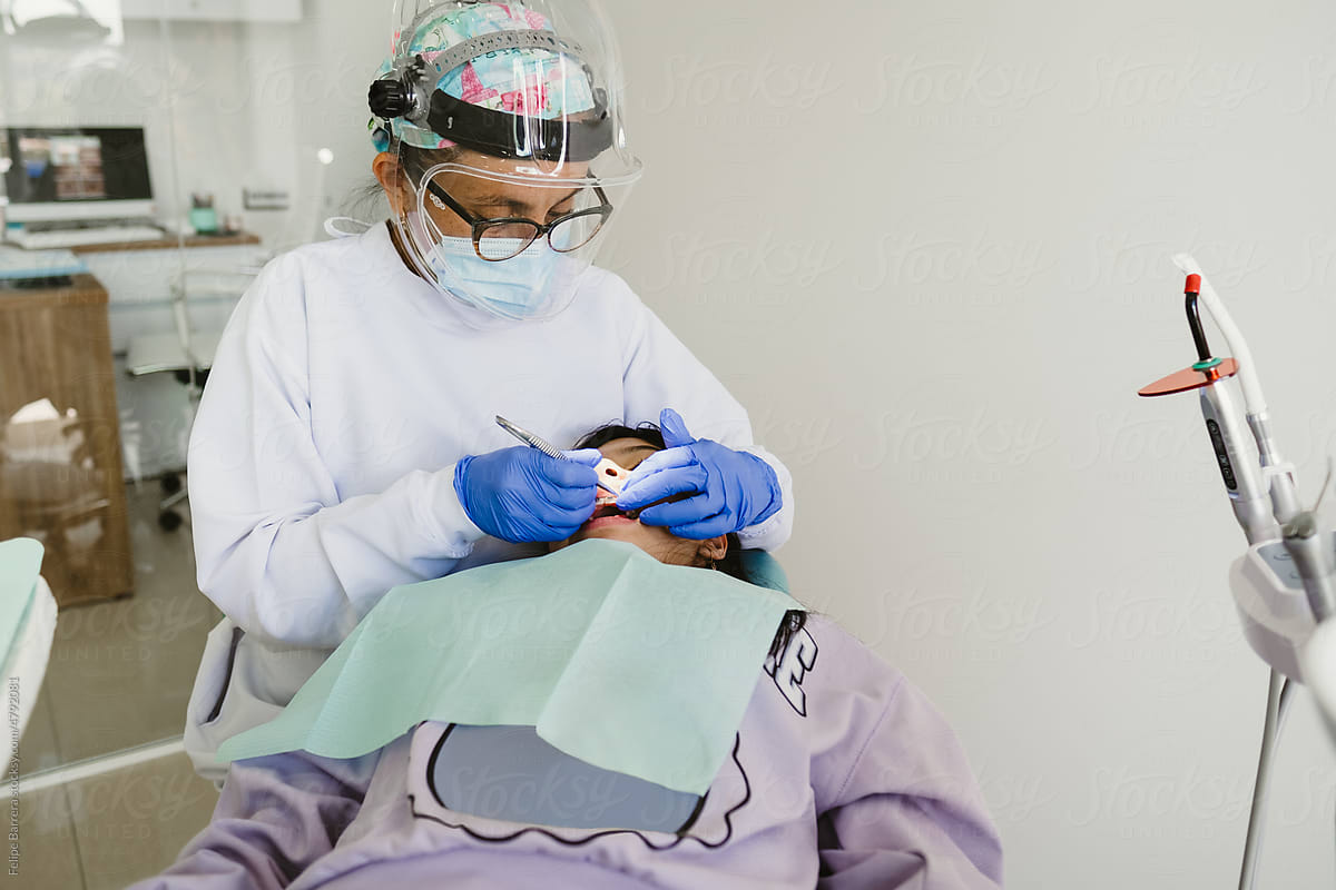Dentist working on a patient in dentist clinic