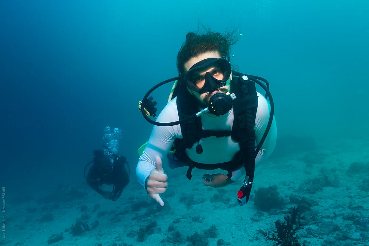 Scuba diver showing hang loose sign underwater