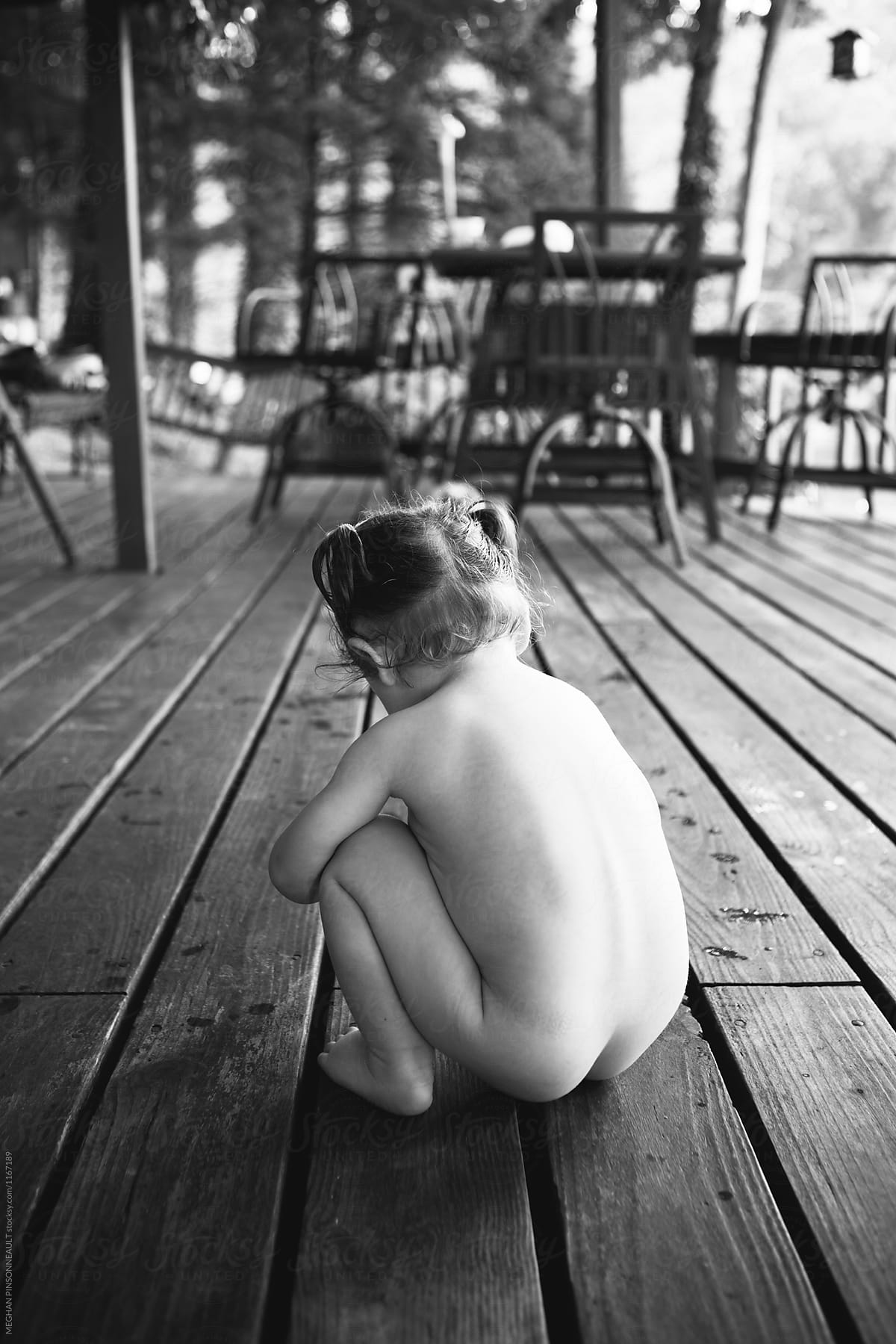 Naked Toddler Plays On Outdoor Lake Deck by MEGHAN PINSONNEAULT.